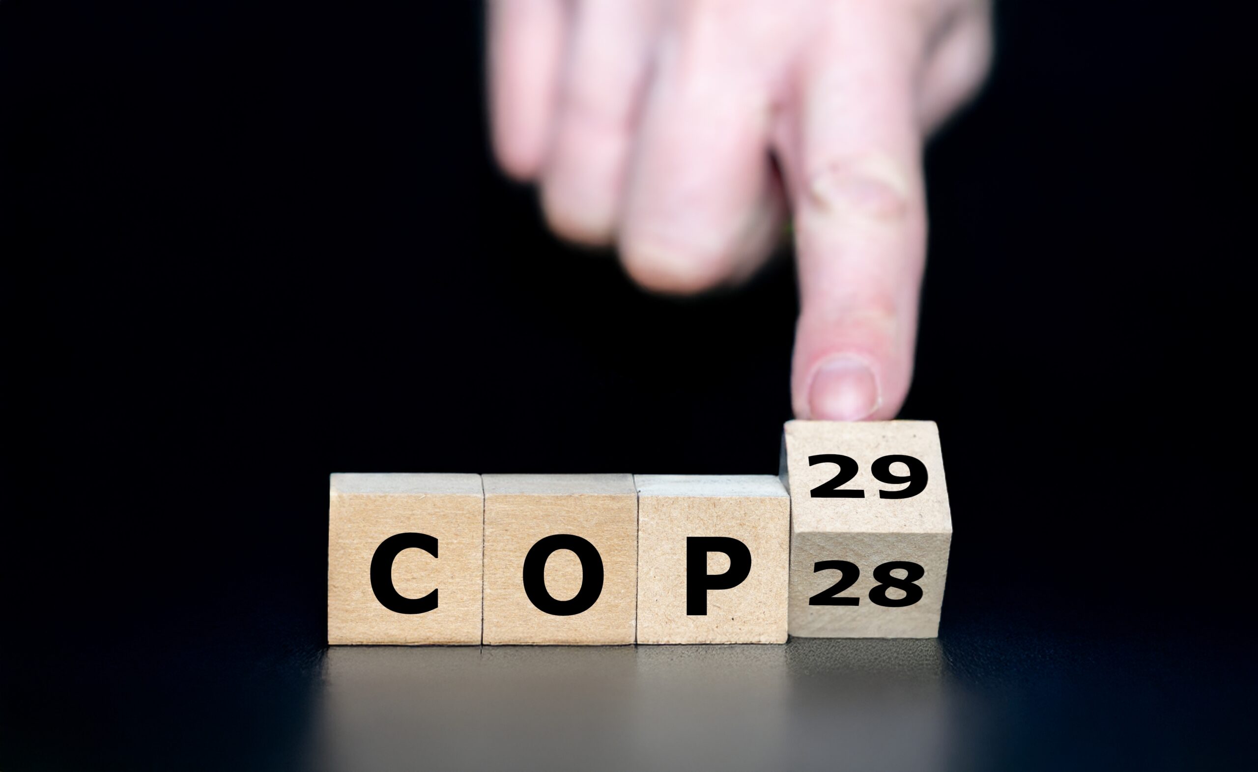 Hand turns cube and changes the expression 'COP 28' to 'COP 29'. Symbol for the 29th Conference of the Parties (COP) in Baku Azerbaijan.